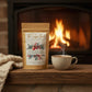 Tea package labeled 'Home for the Holidays Blend' from 'The Sugar Bowl' on a wooden surface.