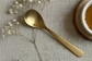 Gold spoon on a textured gray background