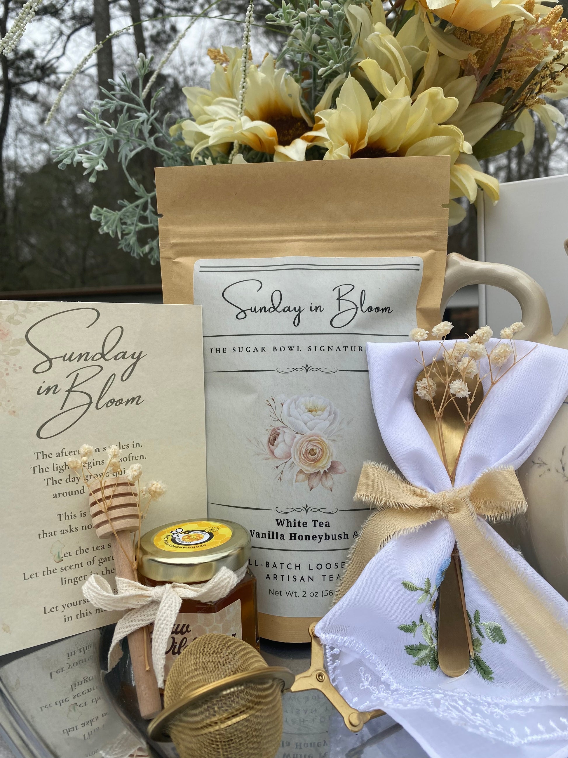 Tea package, mug, honey jar, and other items with 'Sunday in Bloom' branding.